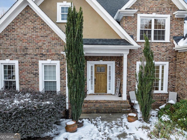 view of snow covered property entrance