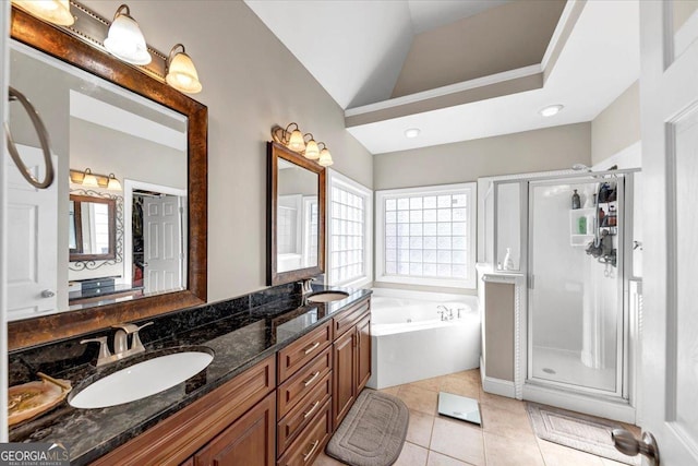 bathroom featuring tile patterned floors, vanity, independent shower and bath, and vaulted ceiling