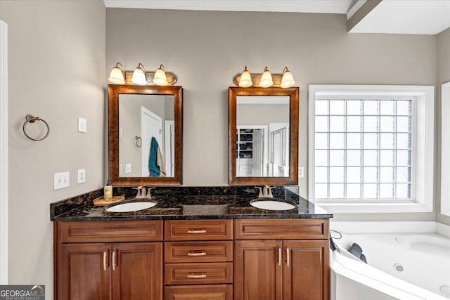 bathroom with vanity and a tub