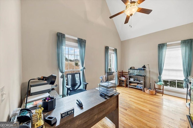 office with ceiling fan, wood-type flooring, and high vaulted ceiling