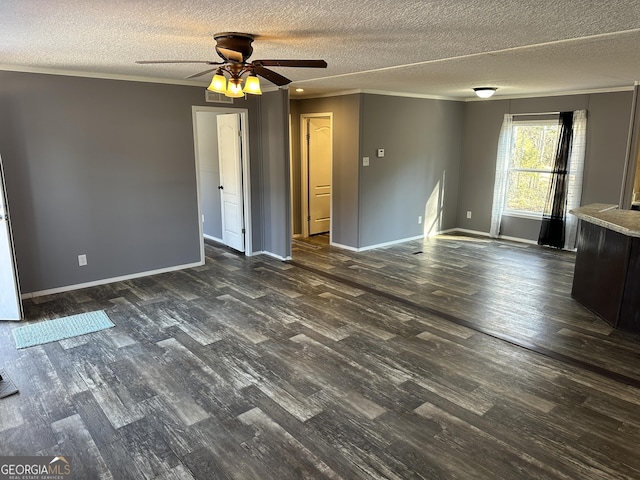 empty room with ceiling fan, dark hardwood / wood-style floors, and a textured ceiling