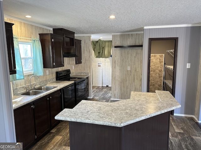 kitchen with dark wood-type flooring, sink, a kitchen island, and black appliances