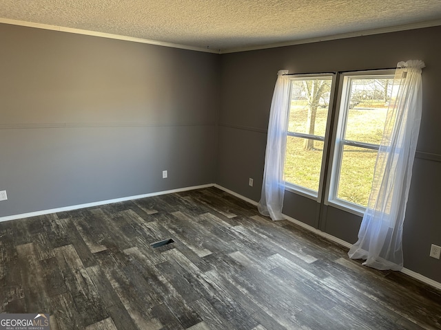 unfurnished room featuring crown molding, a textured ceiling, and dark wood-type flooring