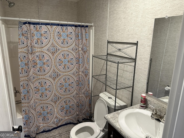 full bathroom featuring vanity, shower / tub combo, and toilet