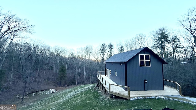 view of side of home with a lawn