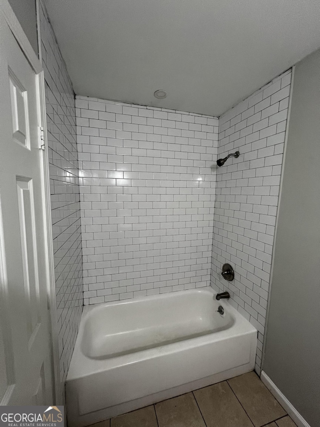 bathroom with tile patterned flooring and tiled shower / bath combo