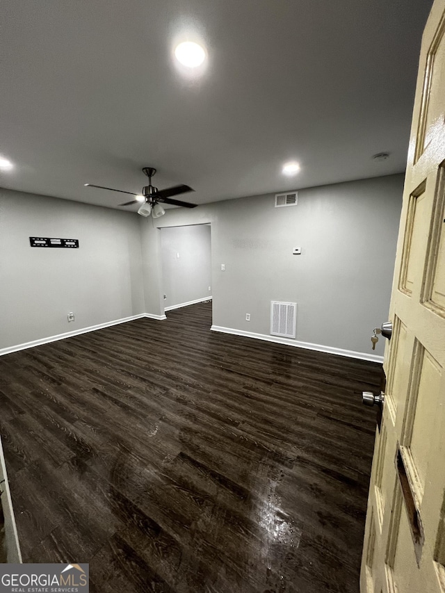 empty room featuring dark hardwood / wood-style floors and ceiling fan