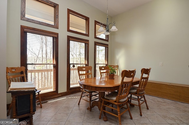 tiled dining area featuring a chandelier