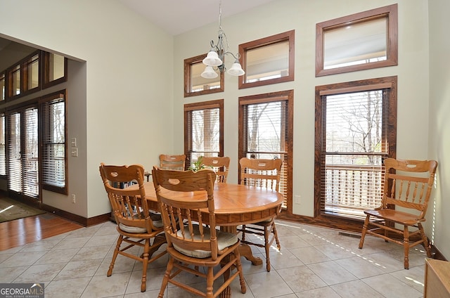 tiled dining area with a chandelier