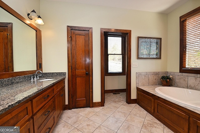 bathroom featuring vanity, a bath, and tile patterned floors