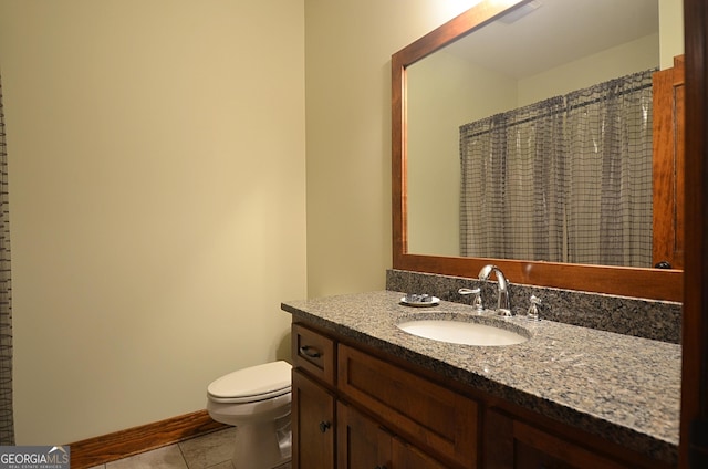 bathroom with vanity, toilet, and tile patterned flooring