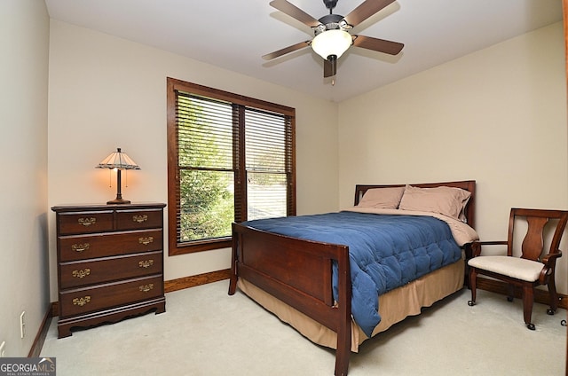 bedroom featuring light colored carpet and ceiling fan