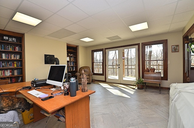 office with french doors, built in features, and a drop ceiling