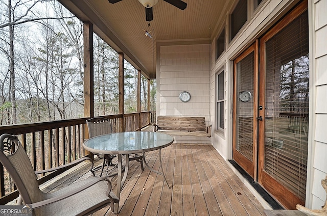 deck with french doors and ceiling fan