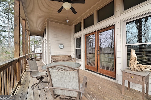 wooden deck featuring french doors and ceiling fan