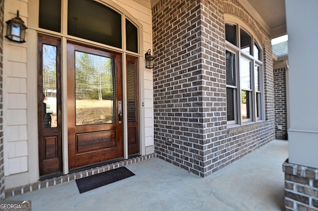 view of exterior entry with covered porch