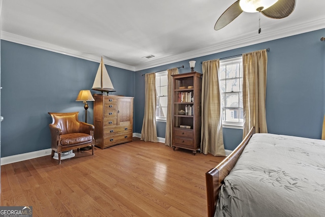 bedroom with wood-type flooring, ornamental molding, and ceiling fan