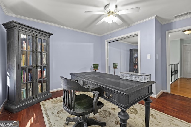 office space featuring dark hardwood / wood-style flooring, ornamental molding, and ceiling fan