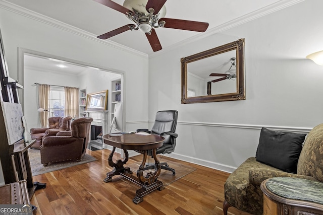 office area with ceiling fan, ornamental molding, and hardwood / wood-style floors