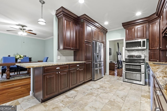 kitchen featuring dark brown cabinets, ornamental molding, a kitchen breakfast bar, pendant lighting, and stainless steel appliances