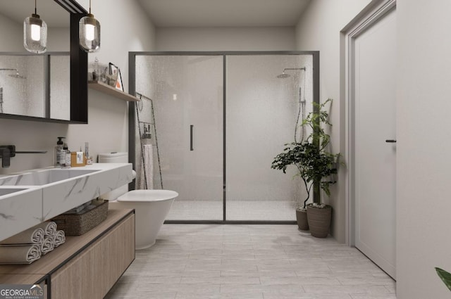 bathroom featuring toilet, a shower with door, and sink