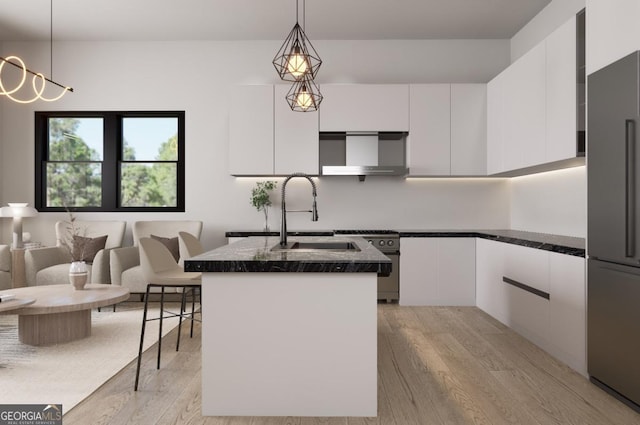 kitchen with white cabinetry, an island with sink, pendant lighting, and premium appliances