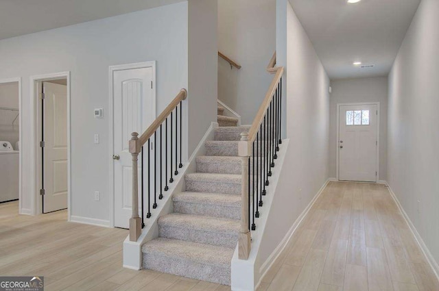 foyer featuring washer / clothes dryer and light wood-type flooring