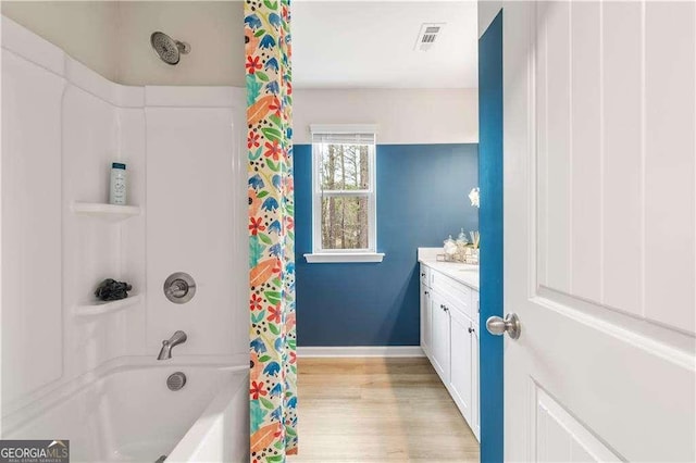 bathroom featuring shower / bath combination with curtain, vanity, and hardwood / wood-style flooring