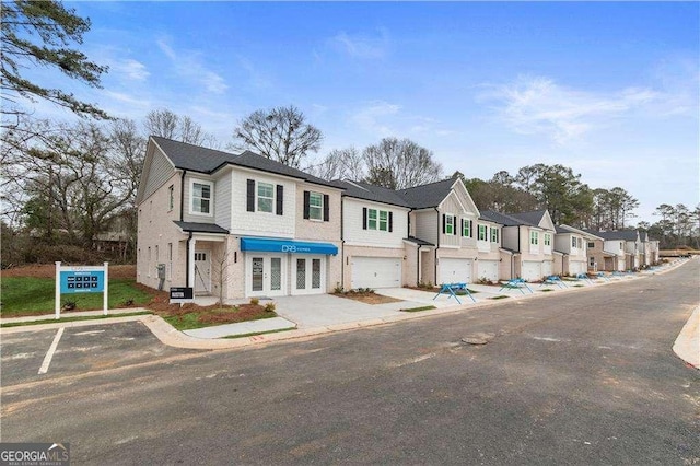 view of property featuring french doors and a garage