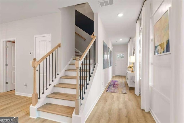 stairs with wood-type flooring