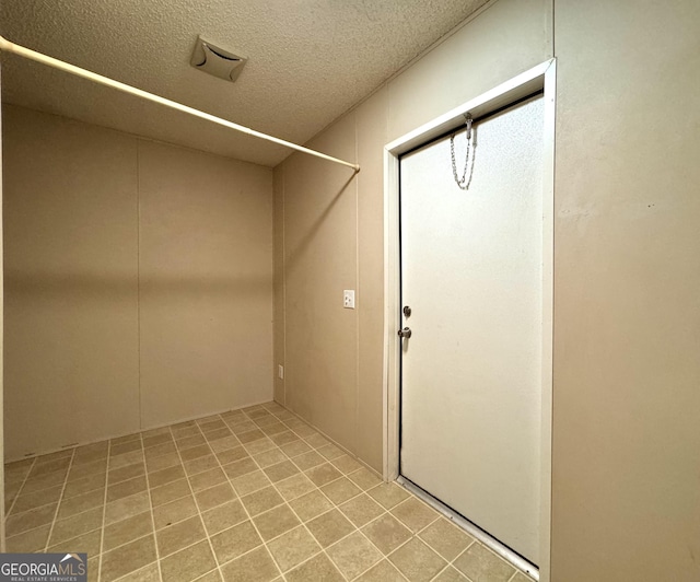 laundry room featuring a textured ceiling