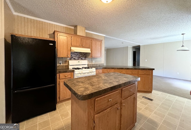 kitchen with black refrigerator, crown molding, gas range gas stove, decorative light fixtures, and a kitchen island