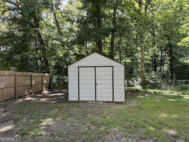 view of outbuilding with a yard