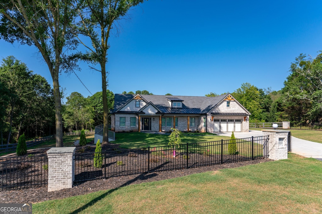 view of front of home with a front yard and a garage