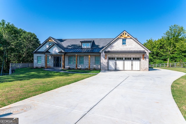 craftsman house with a front yard and a garage