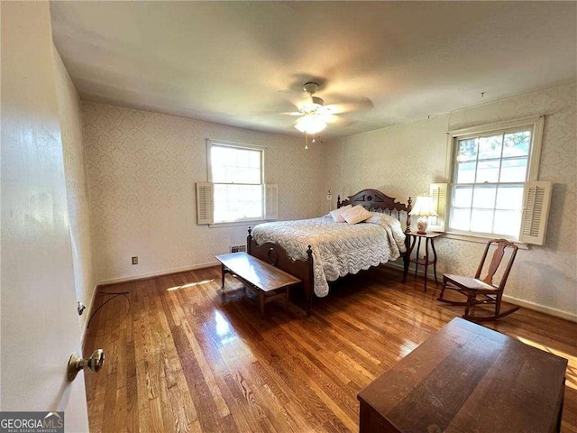 bedroom with ceiling fan and hardwood / wood-style floors