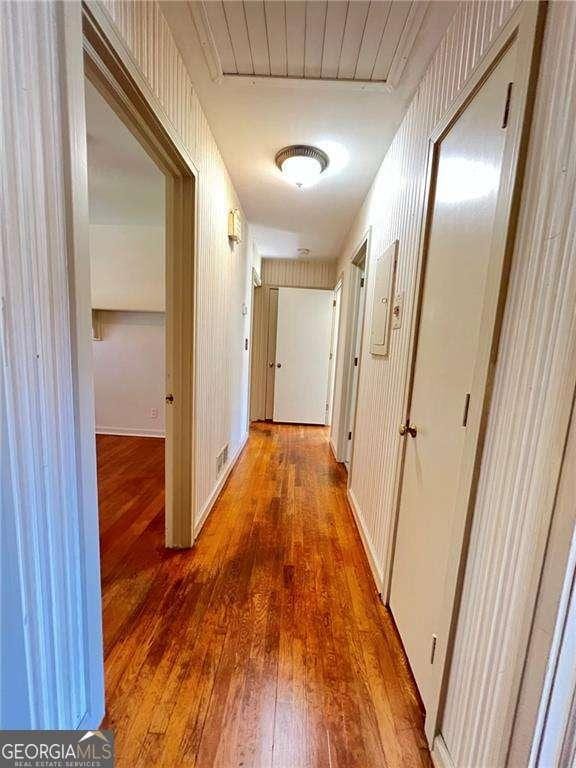 hall with hardwood / wood-style floors