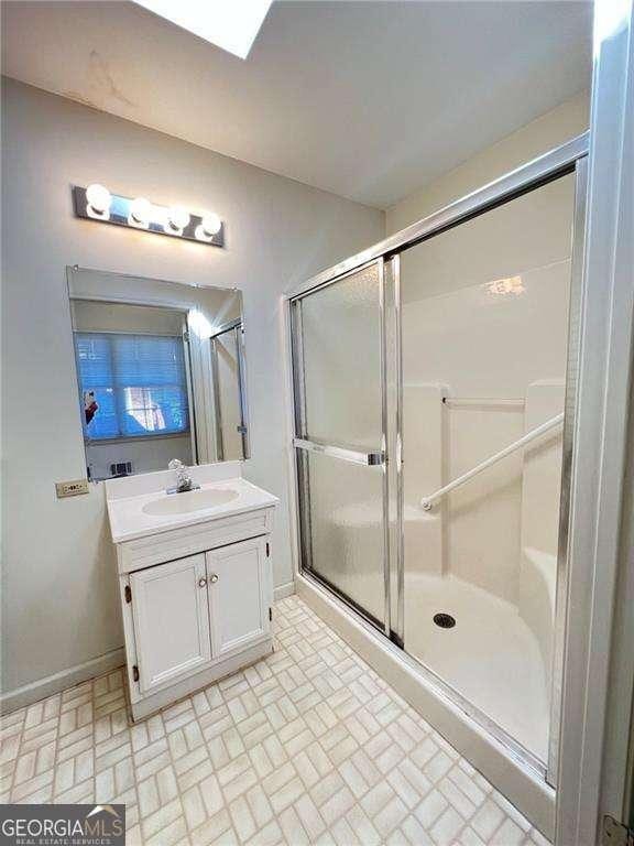 bathroom with vanity and a shower with shower door