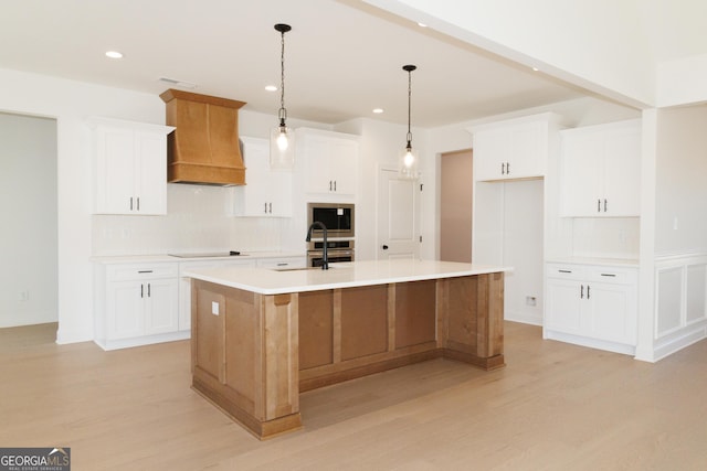 184 Grove Park Unit 11, Senoia, GA 30276 - kitchen with custom exhaust hood, decorative backsplash, light wood-type flooring, a large island, and recessed lighting
