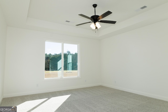 184 Grove Park Unit 11, Senoia, GA 30276 - empty room with a tray ceiling, baseboards, light carpet, and a ceiling fan