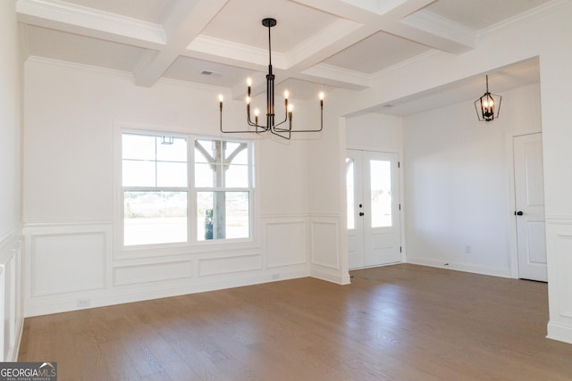 184 Grove Park Unit 11, Senoia, GA 30276 - unfurnished dining area featuring a chandelier, coffered ceiling, beam ceiling, a decorative wall, and wood finished floors