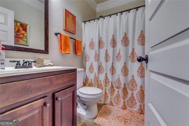 bathroom featuring tile patterned flooring, vanity, toilet, and crown molding