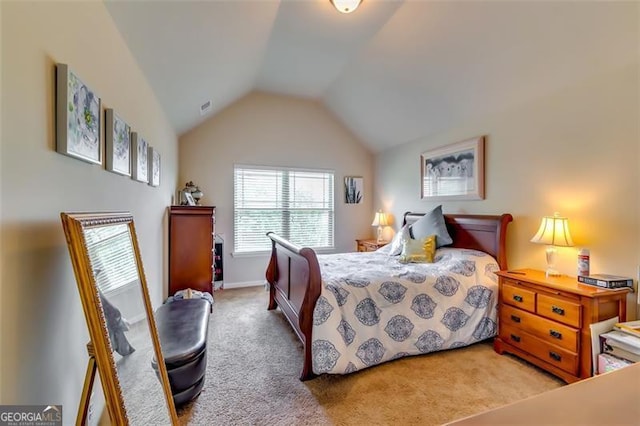 bedroom featuring light colored carpet and lofted ceiling