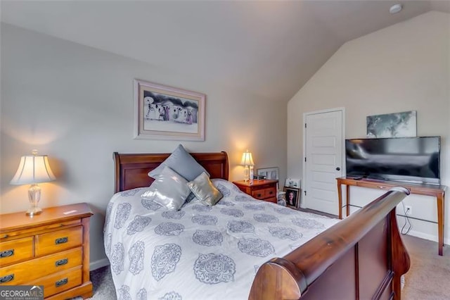 carpeted bedroom featuring vaulted ceiling