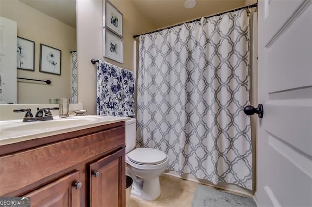 bathroom featuring vanity, toilet, and walk in shower