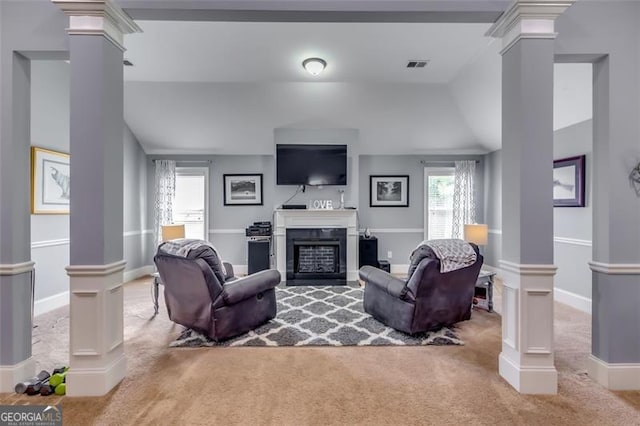 living room with carpet, decorative columns, and lofted ceiling