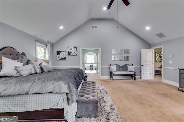 carpeted bedroom with ceiling fan and vaulted ceiling