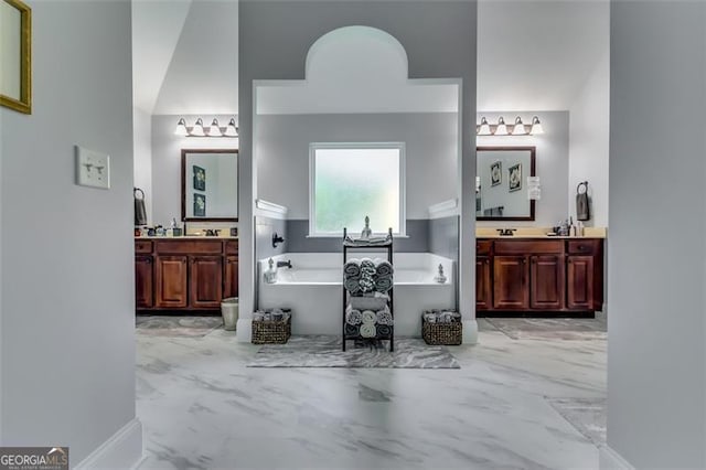 bathroom featuring vanity and a tub to relax in