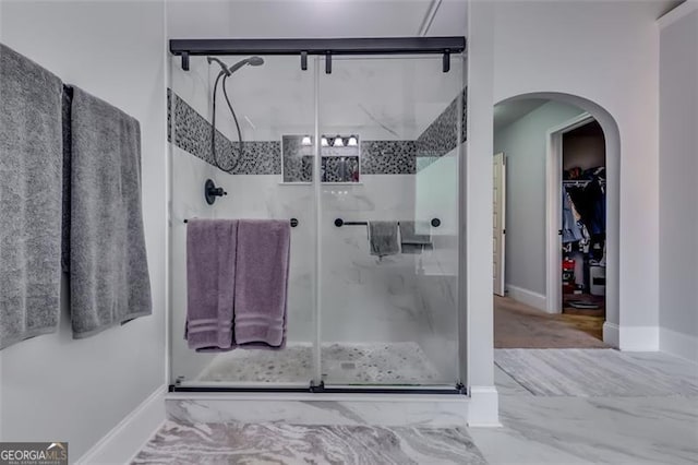 bathroom featuring a shower with door