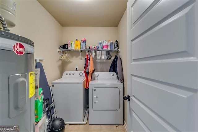 washroom with water heater and independent washer and dryer